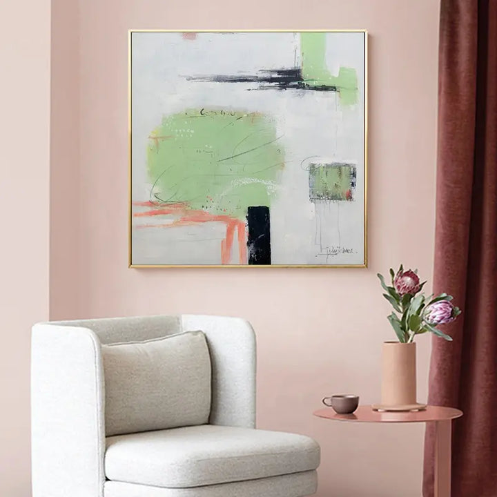 A painting of a serene landscape hangs on the wall of a cozy living room, adding a touch of elegance and tranquility to the space.