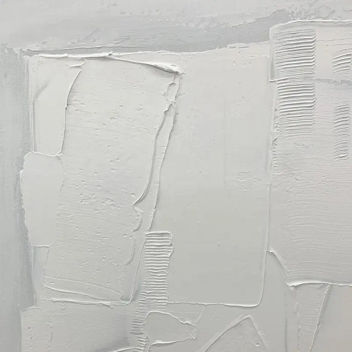 A white painting with subtle white brushstrokes, creating a serene and minimalist composition.